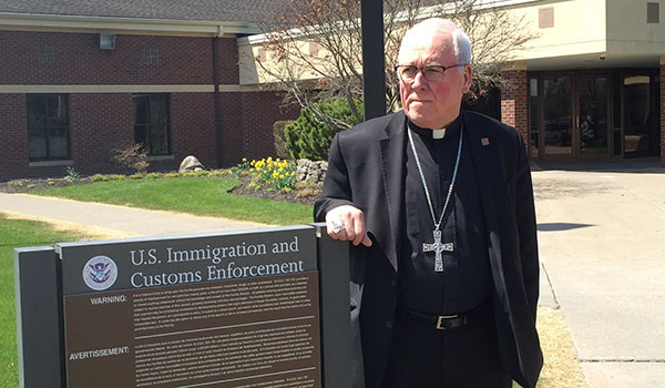 Bishop Richard J. Malone stands outside the Federal Detention Center in Batavia, where he celebrated Mass with detainees on May 1, 2018.