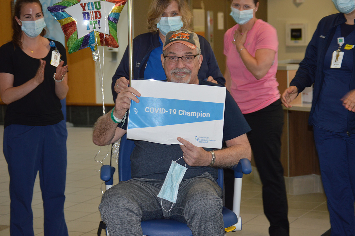 Courtesy of Kenmore Mercy Hospital
Dr. Mark St. Marie, a longtime Mercy Hospital of South Buffalo gastroenterologist, proudly held up a sign reading `COVID-19 Champion` as staff Kenmore Mercy Hospital bid him an emotional farewell on June 5