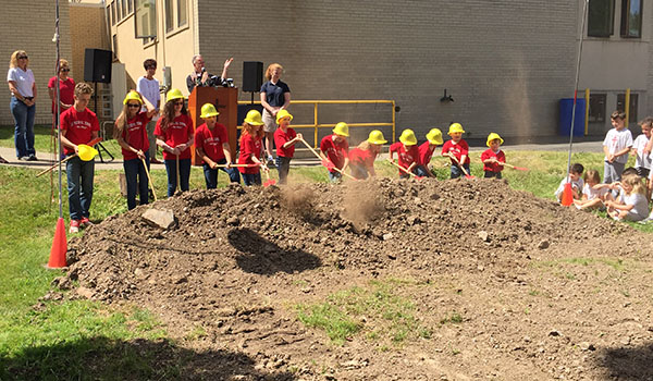 Students at St. Peter R.C. School in Lewiston break ground for a new playground which will be constructed this summer.
