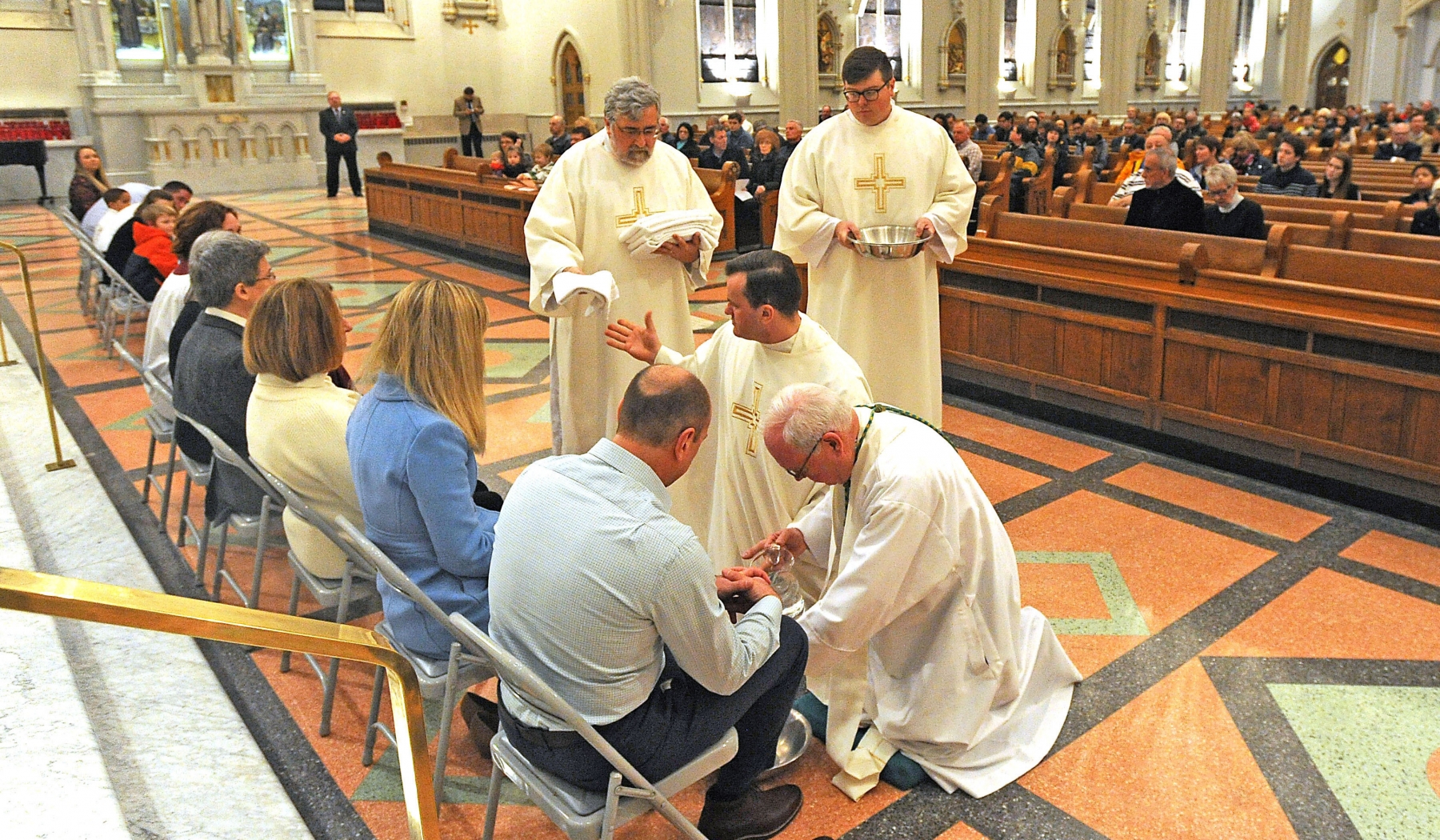 Bishop Richard J. Malone washes the feet of 12 at St. Joseph Cathedral during the Evening Mass of the Lord's Supper.
Dan Cappellazzo/Staff photographer

