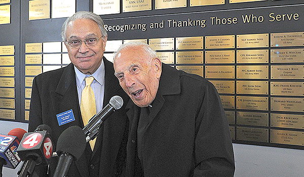 With Naval Park Board Chariman Don Alessi by his side Monsignor Dino J. Lorenzetti, speaks during a ceremony where he was inducted into The Buffalo and Erie County Naval & Military Park Wall of Honor. Dino Lorenzetti proudly served as Staff Sergeant in the U. S. Army's 312th Depot Repair Squadron Supply Unit. He enlisted on November 13, 1942 and was honorably discharged on December 2, 1945. Dan Cappellazzo/Staff photographer