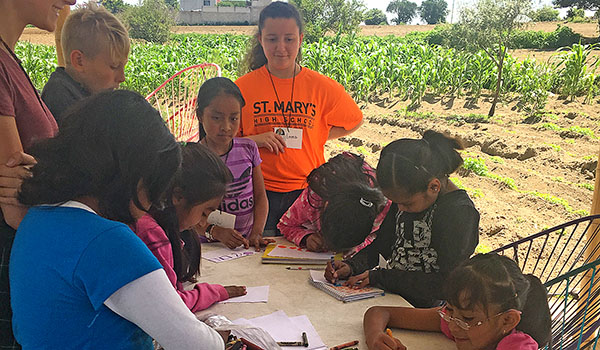 Vincenza LaMagna (left) and Emma Ridolfi, from St. Mary's High School in Lancaster, lead a class for Mexican children at Enlaces Comunitarios Internationales. St. Mary's spent a week in rural parts of Mexico this past summer as part of a service project. (Courtesy of St. Mary's High School)