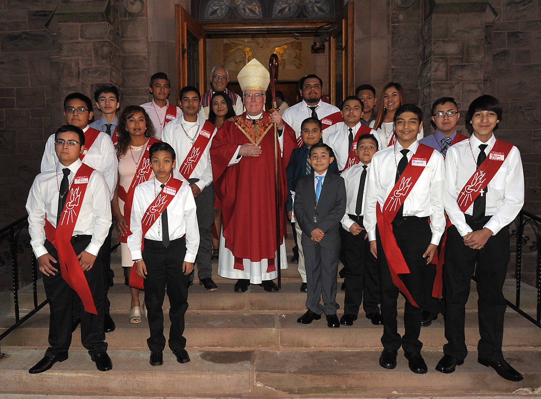 Bishop Richard J. Malone stands with Confirmation candidates at Holy Family Parish, 106 South Main Street, Albion. The students' parents are migrant farm workers. The Mass was said in both English and Spanish.
Dan Cappellazzo/Staff photographer
