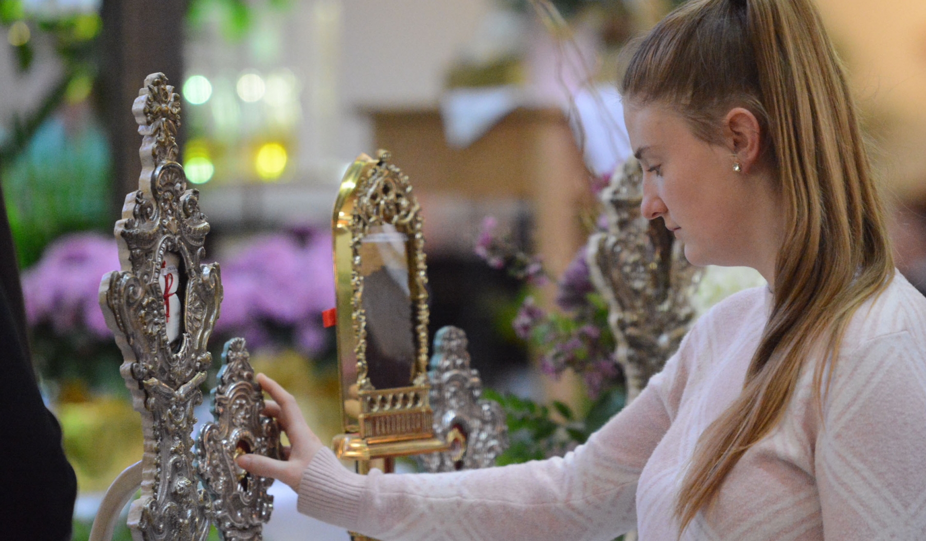 Courtney Kline, St. John Vianney, Orchard Park, touches one of the St. Pio of Pietrelcina relics on display at St. Gabriel Church, Elma. Photo by Patrick McPartland/Managing Editor