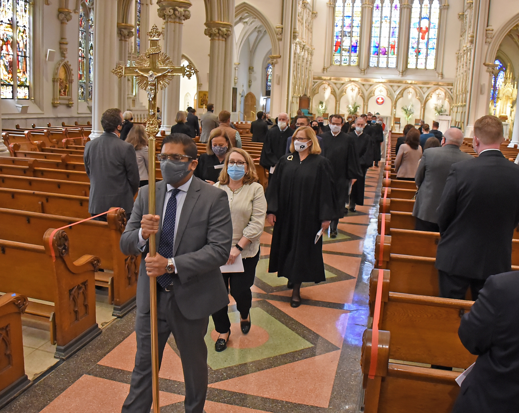 Cross Bearer Royston Mendonza, Board of Directors, St. Thomas More Guild, leads the procession at St. Joseph Cathedral to end the annual Red Mass. (Dan Cappellazzo/ Staff Photographer)