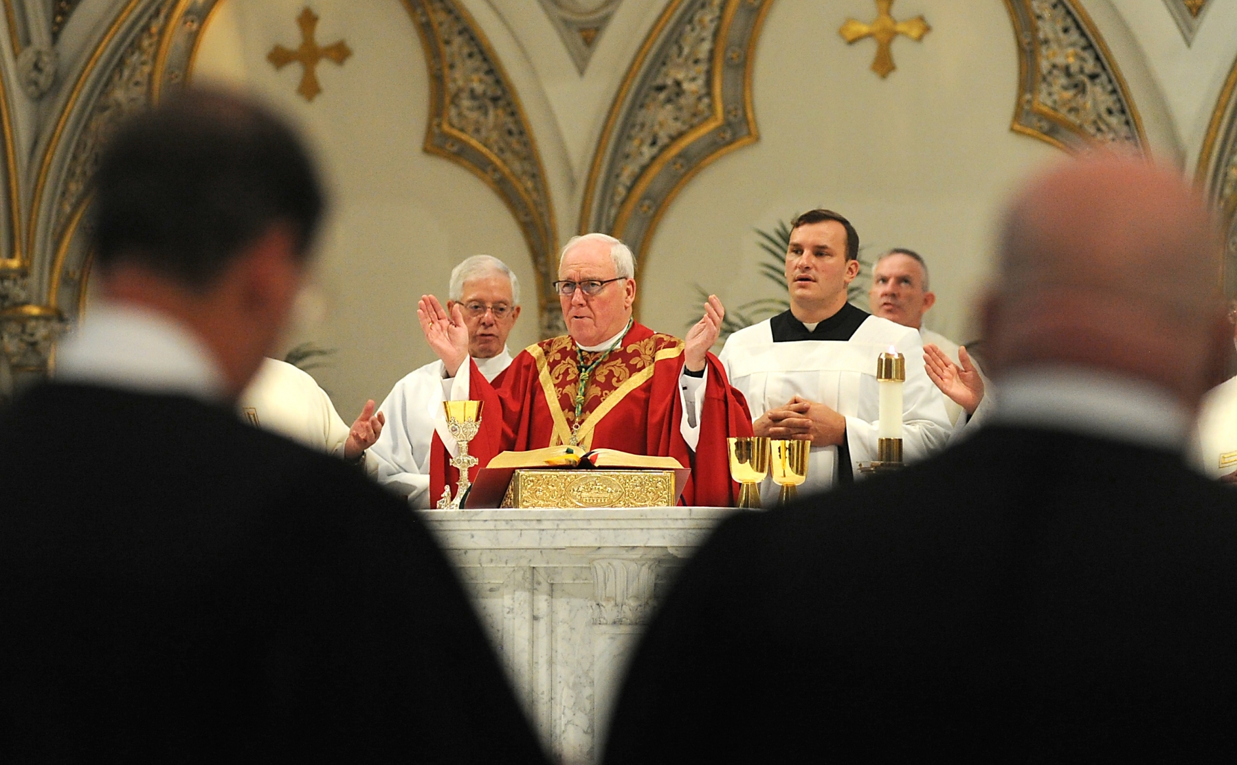 Framed by members of the area judicial system, Bishop Richard J. Malone blesses the Gifts at St. Joseph Cathedral during the annual Red Mass. Area judges, lawyers and public officials of all faiths, their staffs attended the afternoon Mass.The Red Mass dates back to the 13th century when it officially opened the session of the court for most European countries.  It is named for the color of the vestments worn by the celebrants and was offered each fall to invoke divine guidance and strength for those entrusted with the responsibility of the legal and judicial systems.  Dan Cappellazzo/Staff photographer

