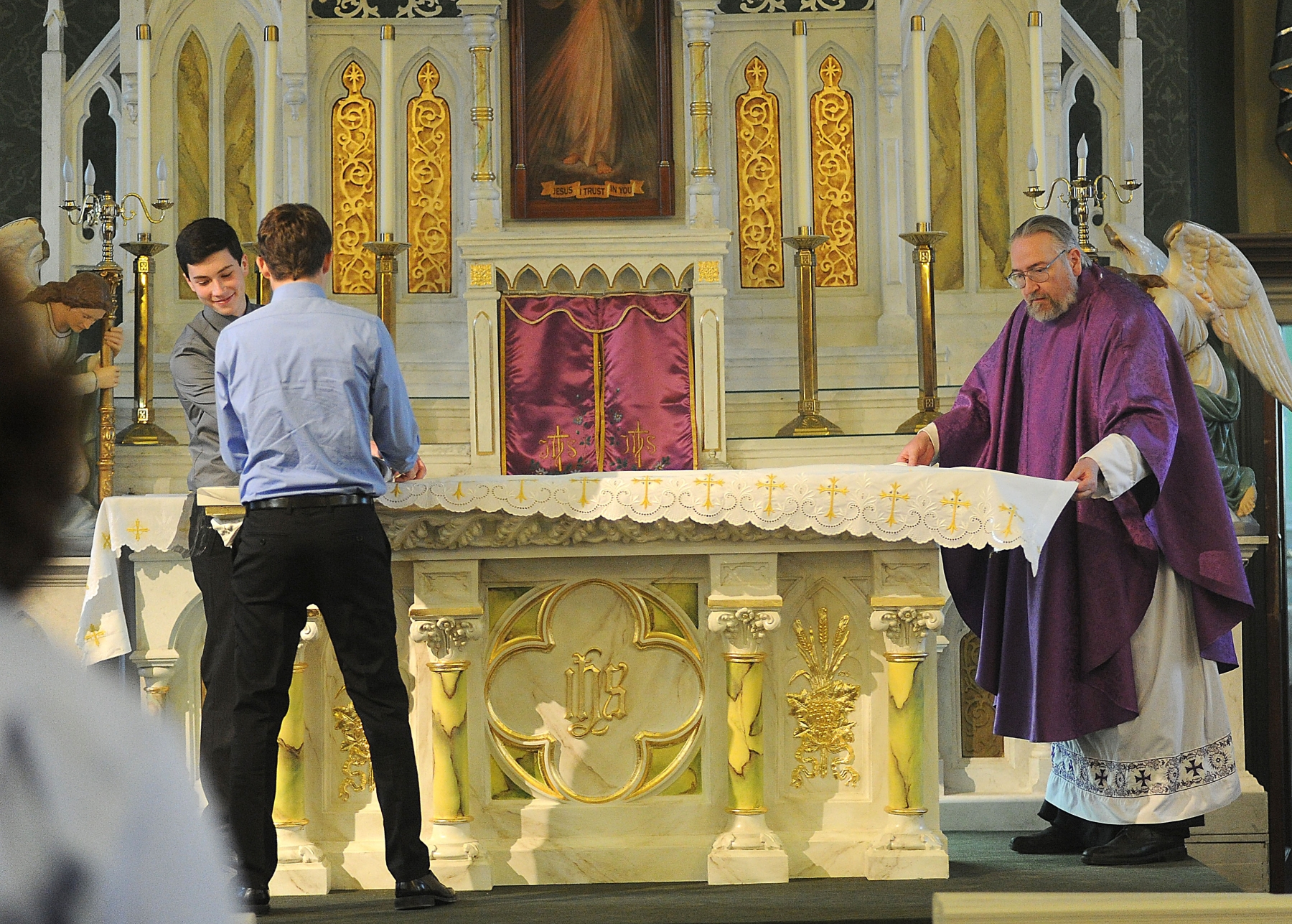 Father Dennis Mancuso prepares the altar at St, Patrick's Church in Belfast. (Dan Cappellazzo/Photographer)
