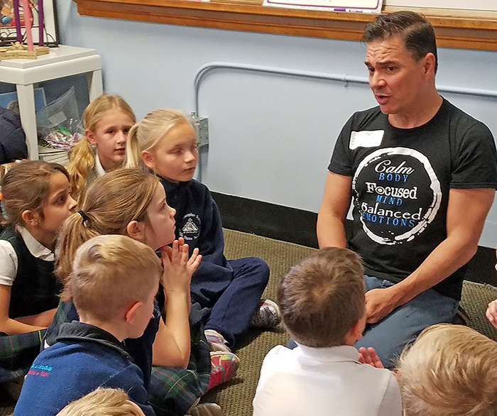 Sean Layne, a teaching artist from the Kennedy Center in Washington, D.C., gives a workshop to St. Christopher students about learning goals focused on teambuilding, accountability and 21st Century Learning Skills. (Courtesy of St. Christopher School)
