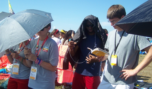 Buffalo Pilgrims listen to Pope Francis' closing Mass for World Youth Day on the radio. Pope Francis delivered the Mass in Spanish and Latin, but translators broadcast many different language versions over the air. (Patrick J. Buechi/Staff) 