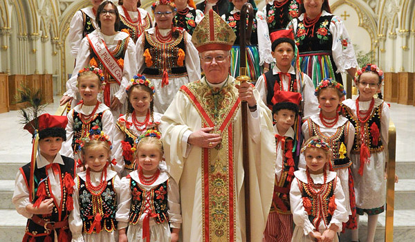 Bishop Malone stands with members of the Polish Heritage Dancers of Western New York after a mass celebrating 1,050 years of Polish commitment to the Catholic faith at St Joseph Cathedral in Downtown Buffalo. (Photo by Dan Cappellazzo)