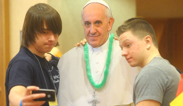 Andrew Deutschman and Noah Sacilowski take a selfie with the Pope Francis cut out at the 63rd Diocesan Youth Convention at Adam's Mark Hotel. Both are from Immaculate Conception Ransomville. (Patrick McPartland/Staff Photographer)