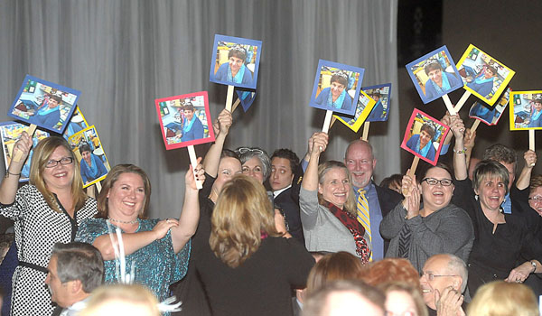 Teachers and staff from St. Peter's School in Lewiston cheer for one of their own as Linda Calandrelli, a Kindergarten teacher at the school, was named the Sister Lucille Socciarelli / Father John Sturm Making a Difference Award at the 15th annual Catholic Education Dinner, now titled GALA 22:6. (Patrick McPartland/Staff Photographer)