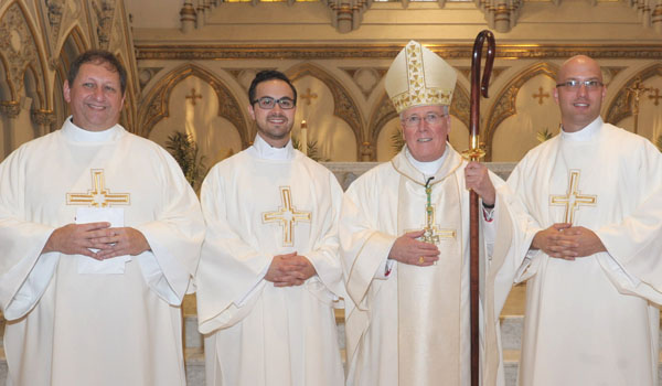 Bishop Richard J. Malone (second from right) will ordain Rev. Mr. Michael Brown (from left), Rev. Mr. Samuel Giangreco and Rev. Mr. Michael LaMarca at St. Joseph Cathedral on May 28. (Patrick McPartland/Staff Photographer) 
