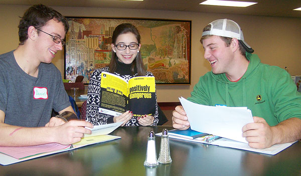 Daniel Ott, Gianella Marciniak and Joshua Fontaine use the book `Positively Dangerous,` by Frank Mercadante, to plan this year's diocesan Youth Convention. Members of the diocesan Youth Board meet regularly throughout the fall and winter to plan the annual event. (Patrick J. Buechi/Staff)