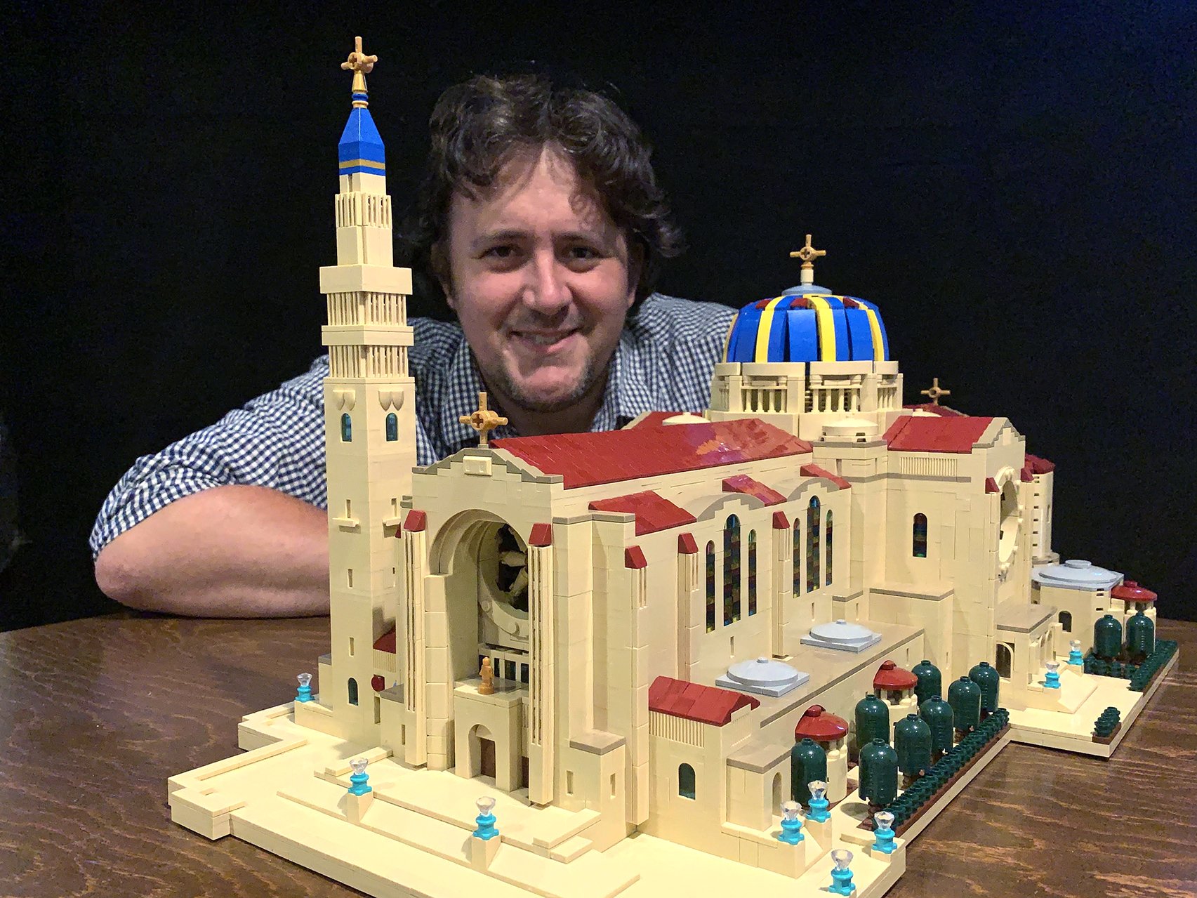 John Davisson poses for a photo with a Lego replica of the Basilica of the National Shrine of the Immaculate Conception in Washington. (CNS photo/courtesy Basilica of the National Shrine of the Immaculate Conception via Catholic Standard)