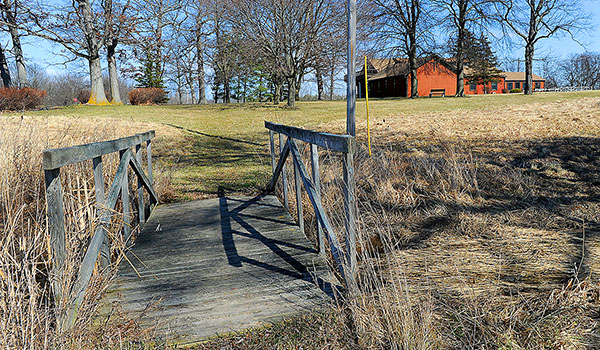 An old wooden bridge crosses a small gully along the walking path to the Abbey of the Genesee. (Dan Cappellazzo/Staff Photographer)