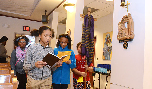 Girl Scouts lead the Stations of the Cross at St. Martin de Porres Church on March 13 as part of the African-American Lenten Scripture Study.
(Patrick McPartland/Staff Photographer)