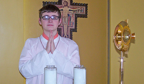 Bryce McLanahan prepares for Mass in the chapel of Cardinal O'Hara High School in Tonawanda. The 18-year-old senior will receive the Altar Server of the Year Award after following his own path of faith. (Patrick J. Buechi/Staff)