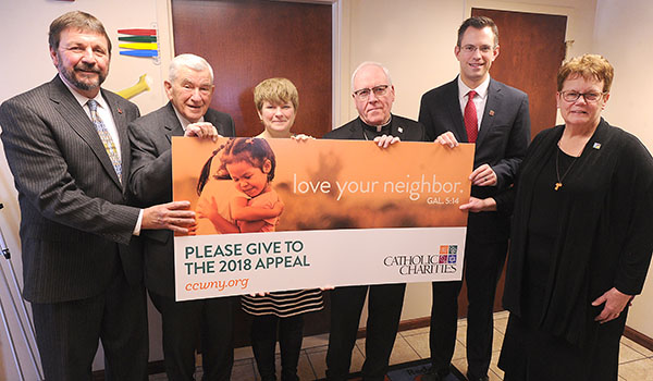 Flanked by Dennis Walczyk, Catholic Charities' chief executive officer, and Sister Mary McCarrick, diocesan director of Catholic Charities of Buffalo, Bishop Richard J. Malone stands with Robert M. Bennett, Chancellor Emeritus of the New York State Board of Regents, as general chair for the 2018 annual Appeal. Bennett's son, Andrew, and daughter, Maurine Falkowski, will serve as co-Appeal chairs, marking the first time in the Appeal's history a family will serve as the campaign's top volunteer leaders. (Dan Cappellazzo/Staff Photographer)

