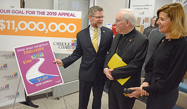 Catholic Charities 2019 Appeal chairs John and Ruthanne Daly speak to Bishop Richard J. Malone after press conference at the CC Workforce & Education Services Center at 1001 East Delavan Avenue where they announced a goal of $11 million. $1.4 million has already been raise for the 2019 `Help your neighbor find HOPE` campaign. (Dan Cappellazzo/Staff Photographer)