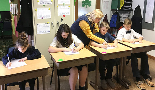 Sue Kroczynski, St. Amelia School Arrowsmith teacher, works with some of her students. (Courtesy of St. Amelia School)