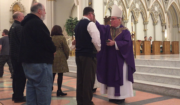 Bishop Richard J. Malone distributed ashes during the noon Ash Wednesday Mass at St. Joseph Cathedral. (Mark Ciemcioch/Online Content Coordinator)