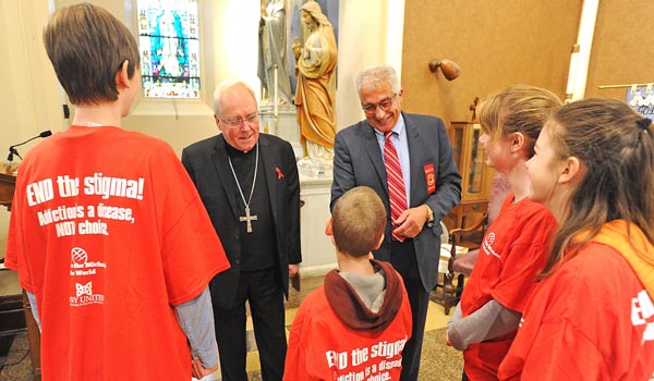 Bishop Richard J. Malone and Avi Israel speak to students at St. Mark Parish in Buffalo about the dangers of substance to mark Red Ribbon Week. Israel, who lost his son to opioid addiction, has shared his story to area children. (Dan Cappellazzo/Staff Photographer)