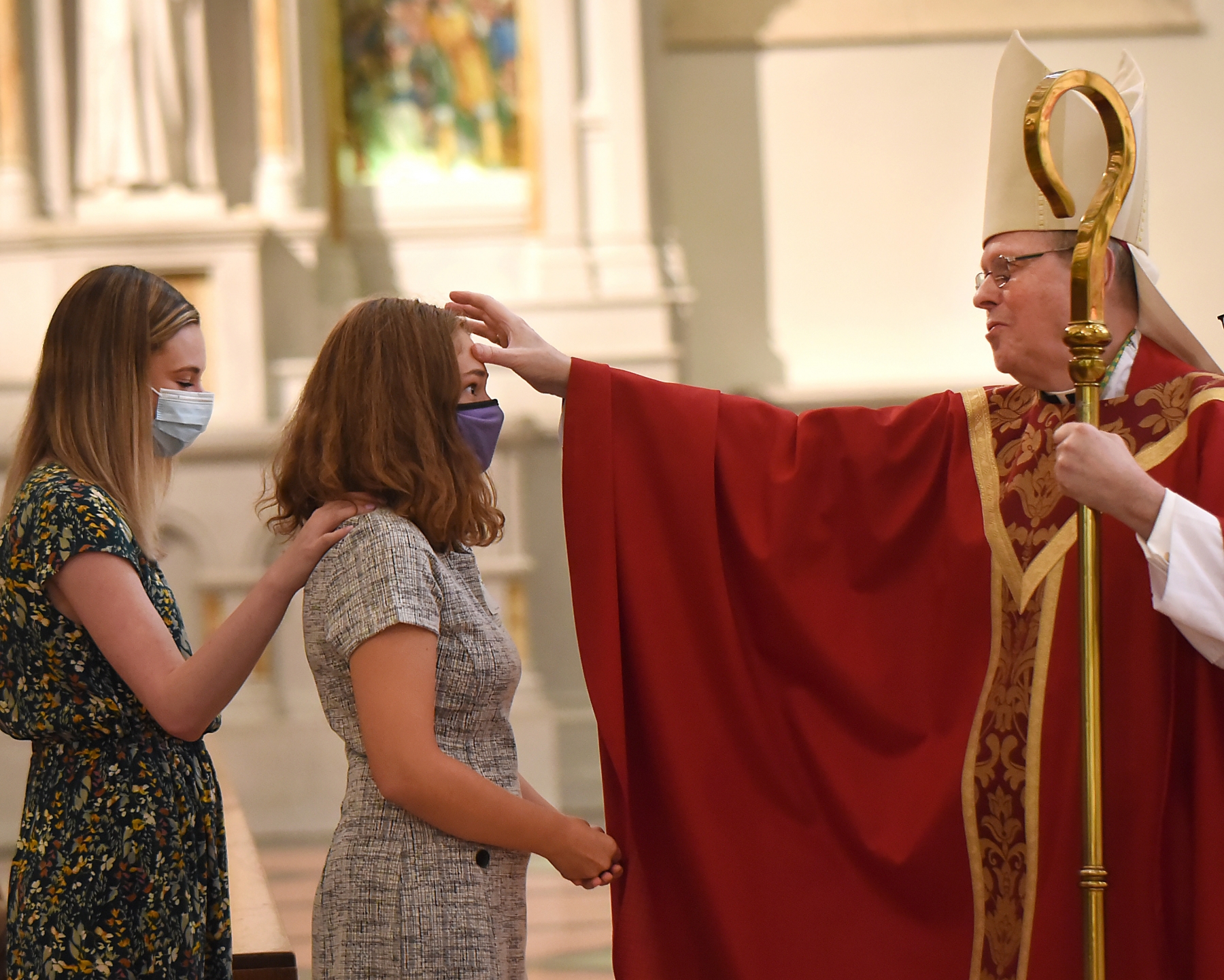 Bishop Edward Scharfenberger confirms Sophia Asher at St. Joseph Cathedral. 27 students were confirmed from six area schools.

Dan Cappellazzo/Staff Photographer