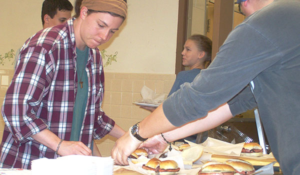 Sarah Saltarelli works with members of the Life Teen programs at St. Bernadette's and the Church of the Annunciation parishes to serve up baloney sandwiches from the St. Bernadette kitchen. Baloneyfest raised money for the youth programs at both parishes. (Patrick J. Buechi/Staff)