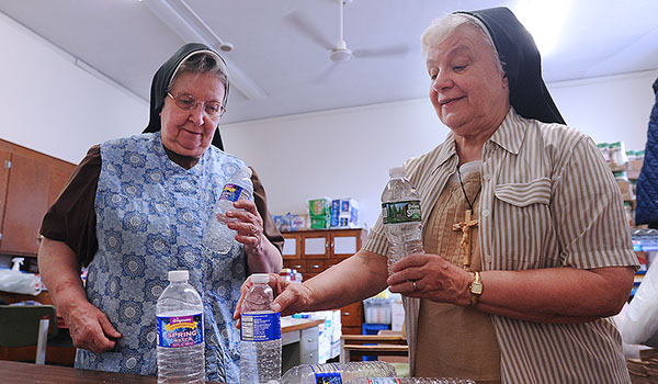 Sister M. Catherine Raczkowski, CSSF, and Sister M. Johnice Rzadkiewicz, CSSF, director of the Response to Love Center, sort water bottles. The center is accepting donations from 19 area can and bottle redemption centers to help offset the cost of operating the community outreach center. (Dan Cappellazzo/Staff Photographer)