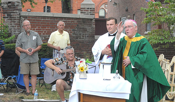 Bishop Richard J. Malone celebrates Mass outside of the Little Portion Friary for the volunteers of the Buffalo homeless shelter. (Patrick J. Buechi/Staff)