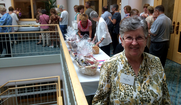 Sister Patricia Burkard, OSF, welcomed visitors to the first `Burgers, Brews and Blues` event Tuesday. (Mark Ciemcioch)