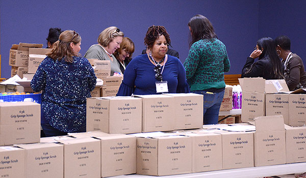 Catholic Charities employees from throughout the country volunteer to help sort donations at the Catholic Charities Lackawanna facility. (Dan Cappellazzo/Staff Photographer)