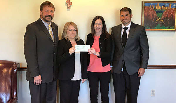 Dennis C. Walczyk (from left), Catholic Charities CEO; Jackie Richter, Catholic Charities director of School Based Services; Jennifer Lyons, Fidelis Care New York director of marketing; and Matt McDonald, Fidelis Care New York marketing manager. (Photo courtesy of Catholic Charities)