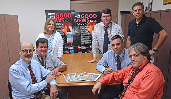 The staff of the Western New York Catholic takes a break after learning they received three awards from the Catholic Press Association. The staff includes (clockwise from front left) Roy Laciura, Darryl Tills, Carolyn Luick, Patrick McPartland, Dan Cappellazzo, Mark Ciemcioch and Patrick J. Buechi. (Dan Cappellazzo/Staff Photographer)