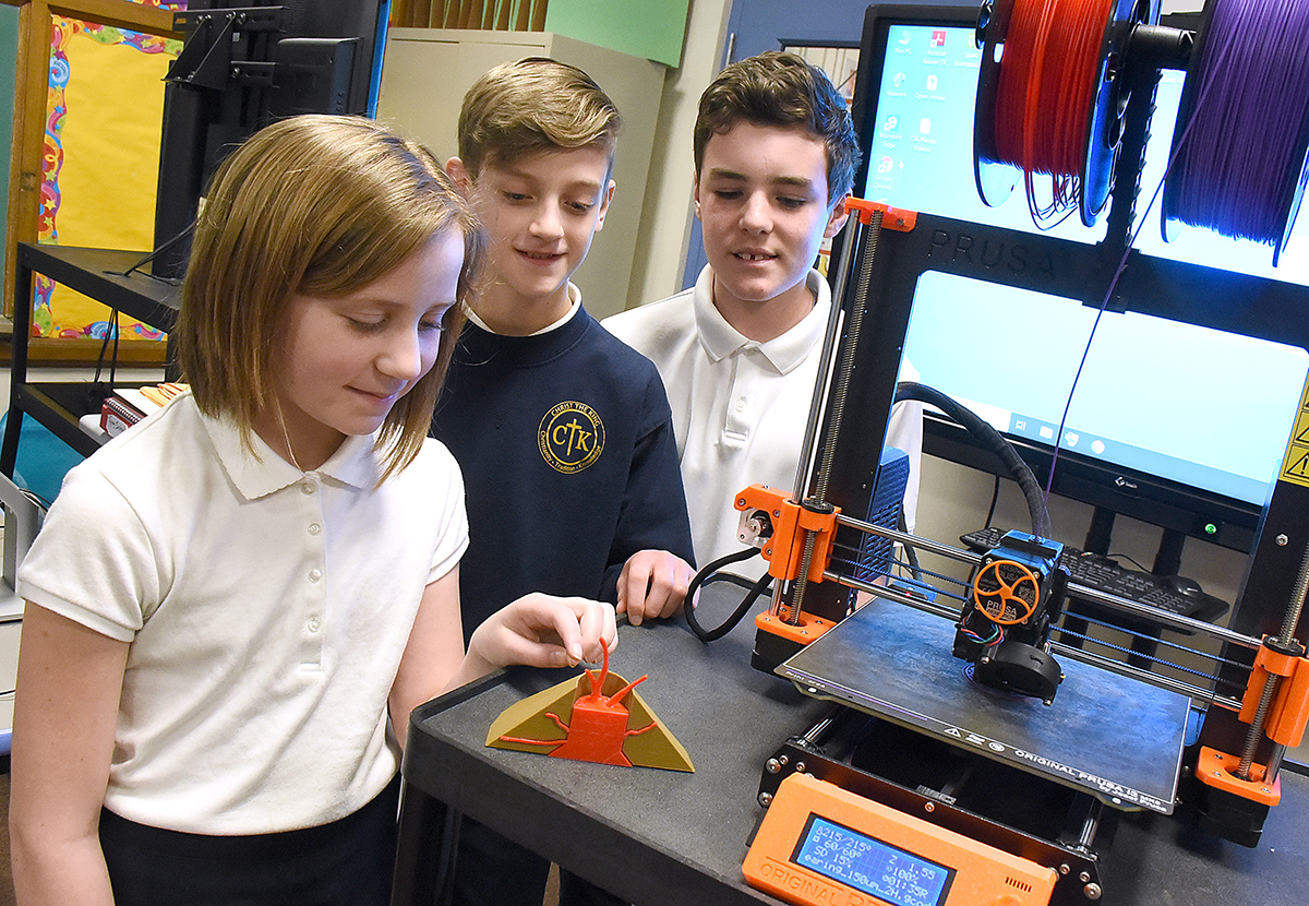Dan Cappellazzo/Staff Photographer
Christ The King School sixth-grade students Fiona Beck, Marco Martino and Michael Pegnia look over the 3D volcano they print in technology class.