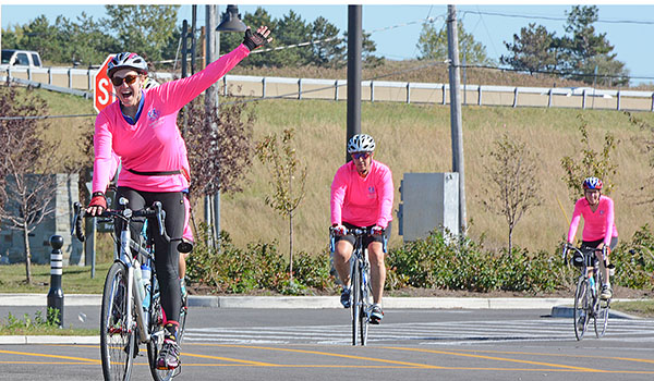 Breanna Mekuly of Erie, Pa., celebrates her arrival to Buffalo's Outer Harbor on Monday, Oct. 2.
Mekuly is with a group of cyclists committed to advancing the mission and image of Catholic sisters arrive at Buffalo's Outer Harbor on their way from North East, Pa., to Niagara Falls, Ontario, Canada. (Patrick McPartland/Managing Editor)