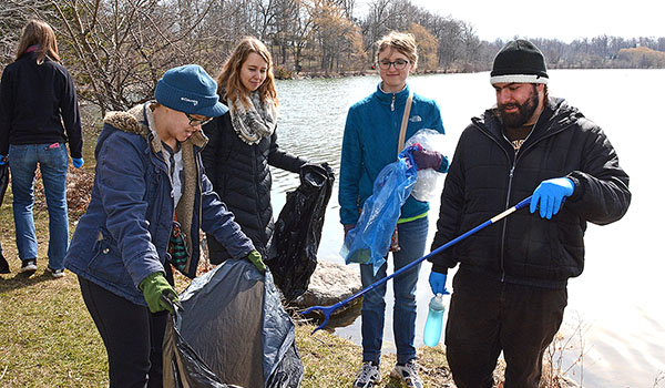 Members of the St. Benedict Creation Care Team Maria Chomicka (from left), Victoria Erdman, Chelsea Brodka and Joe Vertino volunteer their time to clean up around Hoyt Lake in Delaware Park. The clean up was part of the Waterkeepers annual Spring cleanup. (Patrick McPartland/Managing Editor)