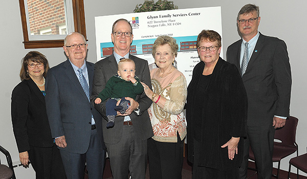 Three generations of Glynn's - James Glynn, his wife Mary, fourth from the left, son Christopher, holding his son 9-month-old Christopher M. Glynn Jr., stand with Catholic Charities COO Tish Brady, Sister Mary McCarrick, OSF, diocesan director ofCatholic Charities and Paul Dyster, mayor of Niagara Falls at a press conference to announce the start of construction for the renovation of the former school of Holy Family of Jesus, Mary and Joseph Parish in Niagara Falls. A generous gift was announced from the Glynn family, who's name will be on the center. (Dan Cappellazzo/Staff Photographer)