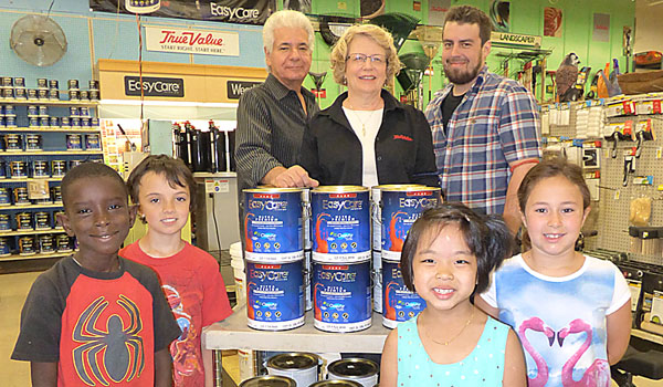 First- and second-grade students from Catholic Academy of West Buffalo stand with Dibble's True Value owners Tenso Japadjief, his wife Jane and son Daniel. (Courtesy of Catholic Academy)