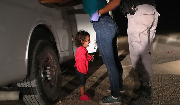 A two-year-old Honduran asylum seeker cries as her mother is searched and detained near the U.S./Mexico border on June 12, 2018 in McAllen, Texas. The asylum seekers had rafted across the Rio Grande from Mexico and were detained by U.S. Border Patrol agents before being sent to a processing center for possible separation. Customs and Border Protection (CBP) is executing the Trump administration's `zero tolerance` policy towards undocumented immigrants. U.S. Attorney General Jeff Sessions also said that domestic and gang violence in immigrants' country of origin would no longer qualify them for political asylum status. (Photo by John Moore/Getty Images)