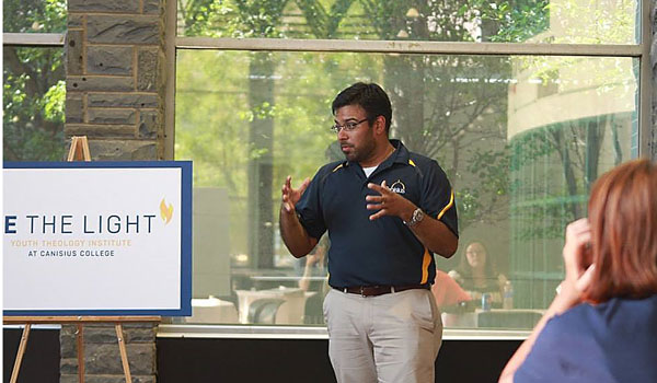 Stephen Chanderbhan, director of the Youth Theology Institute at Canisius College, talks with high school students about `a faith that does justice` at the Be the Light Institute. (Courtesy of Darby Ratliff)