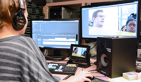 Daybreak TV's Ashley Czarnota works in the control room at the Catholic Center. Every weekday morning, Daybreak TV records the 7:30 a.m. Mass at St. Joseph Cathedral in Buffalo for broadcast at noon. (Patrick McPartland/Managing Editor)