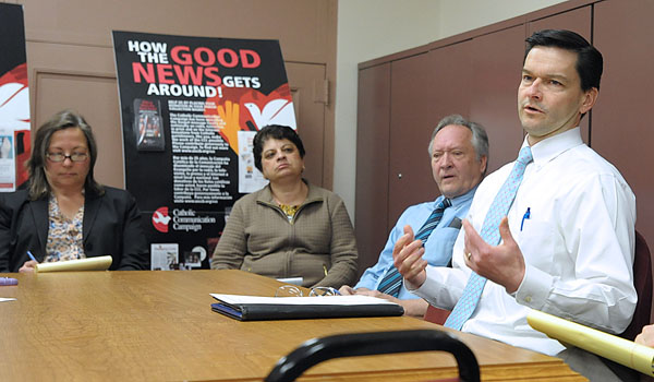 At a staff meeting, George Richert (right), director of the Office of Communications, gives an update on projects and ideas on which the staff is working. (Patrick McPartland/Staff Photographer)