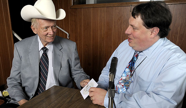 Gregg Prince, director of Diocesan Radio Ministry, drops off a recording of Western New York Catholic Weekly to Ramblin' Lou Schriver, the longtime owner of WXRL Radio in Lancaster. (Patrick McPartland/Staff Photographer)