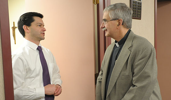 George Richert (left) talks with Father Richard `Duke` Zajac, chairman of this year's Catholic Communications Campaign. (Patrick McPartland/Staff Photographer)