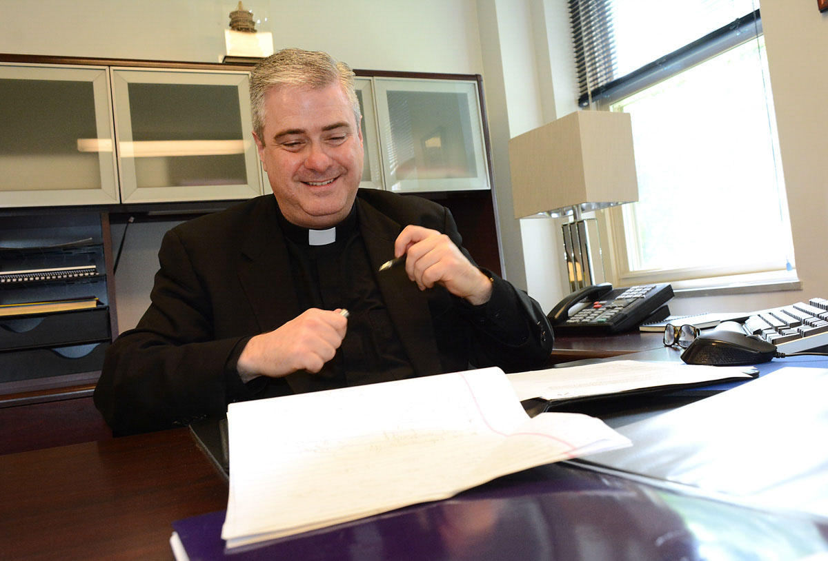 Father Kevin G. Creagh, the new president-rector of Christ the King Seminary, works in his office at the East Aurora campus. Creagh was formerly the vice president for international relations and the special assistant to the provost at Niagara University. Dan Cappellazzo/Staff Photographer