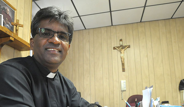 Father George Devanapalle feels at home as administrator of SS. Joachim and Anne Parish in Attica. (Patrick McPartland/Staff Photographer)
