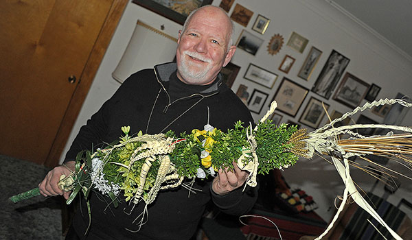 Father Czeslaw M. Krysa, of St. Casimir Church, shows off a palm he wove. He holds seminars to teach people this tradition every year during Lent. (Dan Cappellazzo/Staff Photographer)