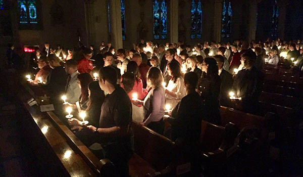 The assembly shared the flame of the Paschal Candle with each other at the beginning of Saturday's Easter Vigil. (Mark Ciemcioch/Online Content Coordinator)